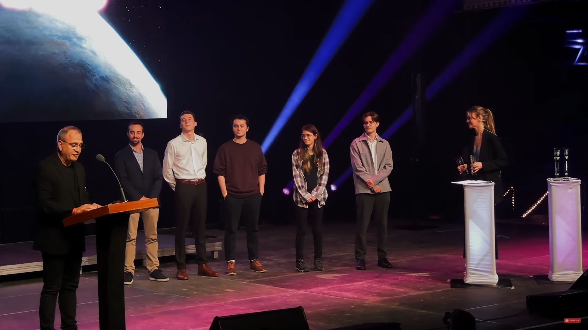 Team photo on stage during the ceremony.